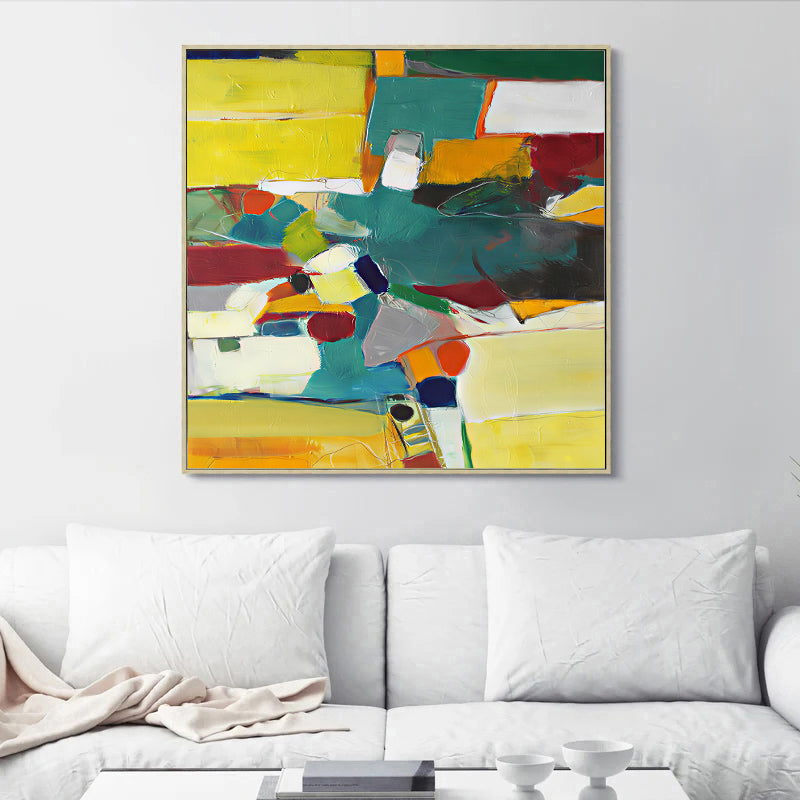 Abstract colorful painting on a wall above a white sofa
