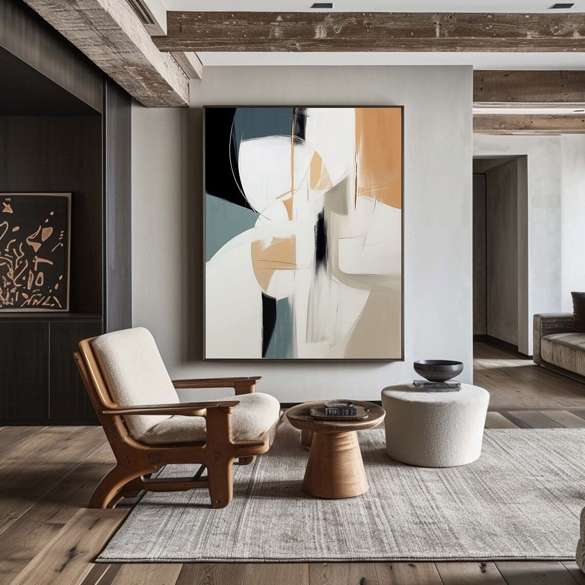 Modern living room with abstract art, wooden armchair, and round coffee table.