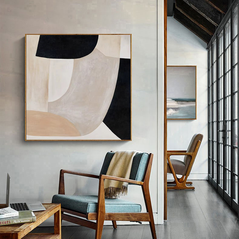 Modern interior with abstract art on the wall and a chair with a blanket.