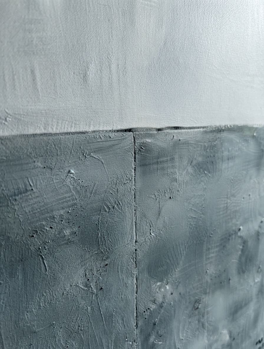 Large textured blue and gray abstract canvas art with minimalist modern design by Noho Art Gallery with a horizontal seam dividing the composition, featuring a light gray upper section and a darker charcoal gray lower section.