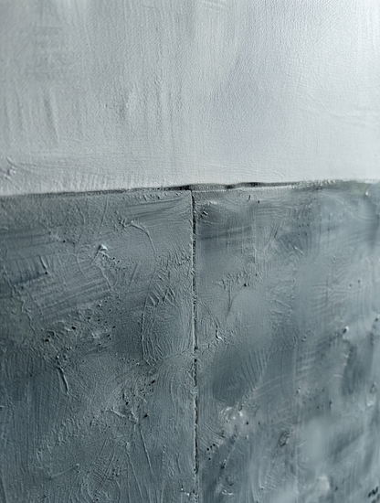 Large textured blue and gray abstract canvas art with minimalist modern design by Noho Art Gallery with a horizontal seam dividing the composition, featuring a light gray upper section and a darker charcoal gray lower section.