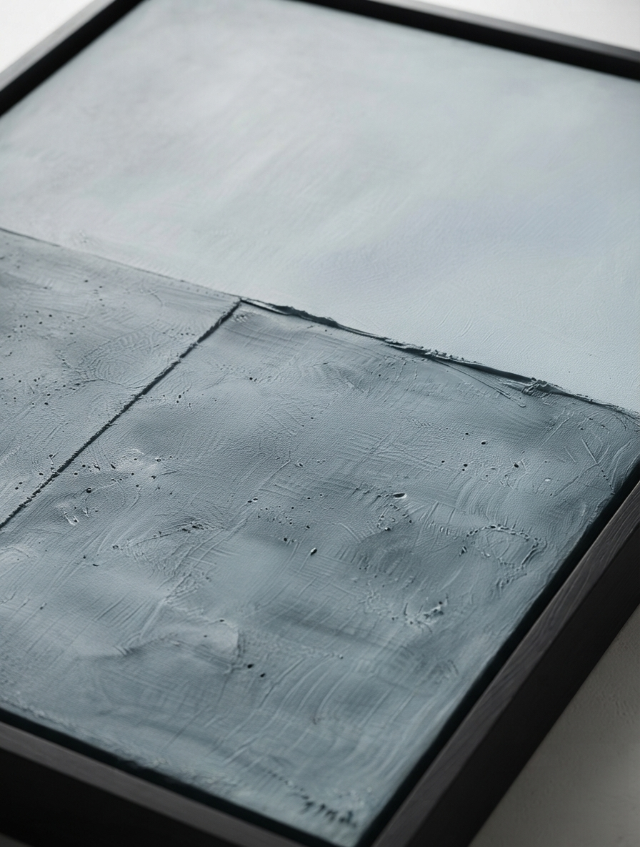 Close-up of a framed modern minimalist wall art with elegant blue and gray textured canvas by Noho Art Gallery sections and a dark frame.