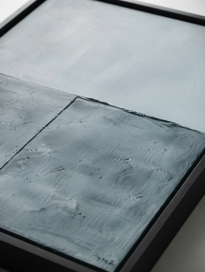 Close-up of a framed modern minimalist wall art with elegant blue and gray textured canvas by Noho Art Gallery sections and a dark frame.