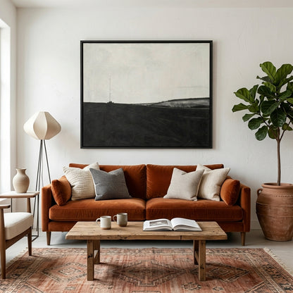 Cozy living room with a brown sofa, wooden coffee table, and a Hand-painted monochrome landscape artwork by Noho Art Gallery