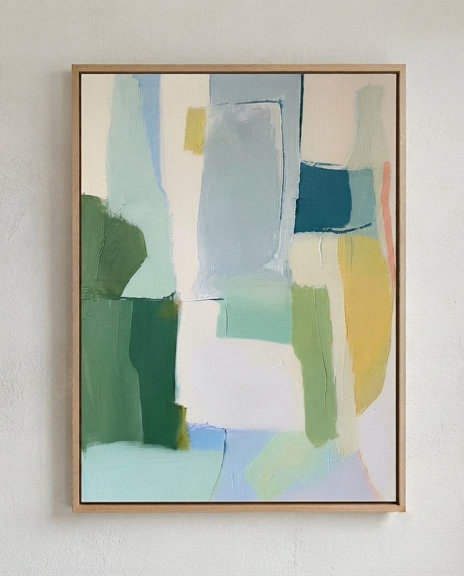 An Large Sage Green and Blue Minimalist Abstract Canvas Painting by Noho Art Gallery with geometric blocks of green, blue, yellow, and white, hung on a textured off-white wall.