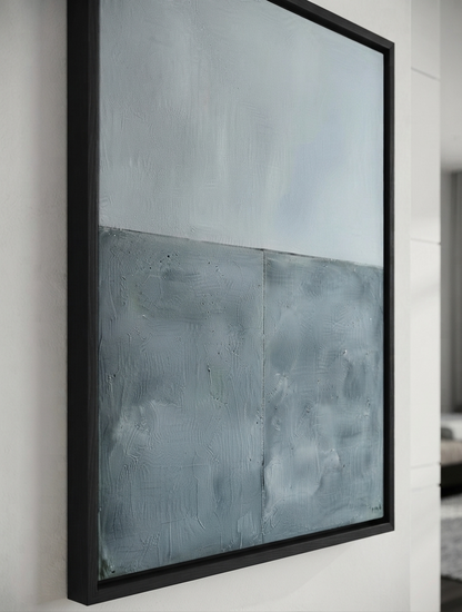 Large modern abstract art for sale with textured blue and gray acrylic finish by Noho Art Gallery with a light blue-gray upper section and a darker blue-gray lower section, enclosed in a thick black frame and mounted on a white wall.