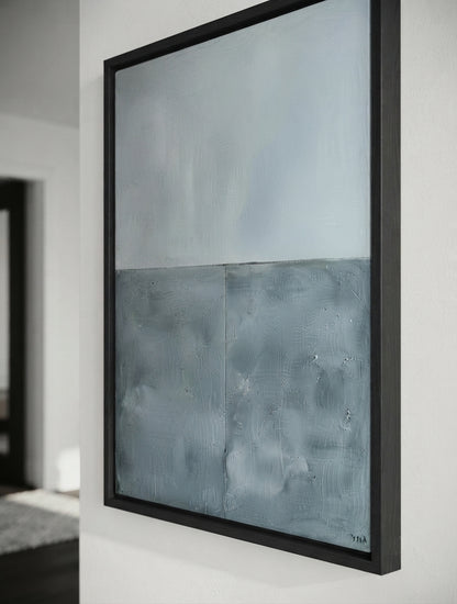 Neutral blue gray textured wall art for Scandinavian and contemporary interiors by Noho Art Gallery hanging on a white wall, featuring a textured split design with a light gray upper half and a darker blue-gray lower half, enclosed in a black frame.
