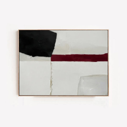 A Minimalist black and white abstract canvas with red accent, hand-painted modern abstract art for minimalist office by Noho Art Gallery featuring a bold black block, a horizontal deep red stripe, and textured off-white background blocks, enclosed in a thin light wood frame against a white wall.