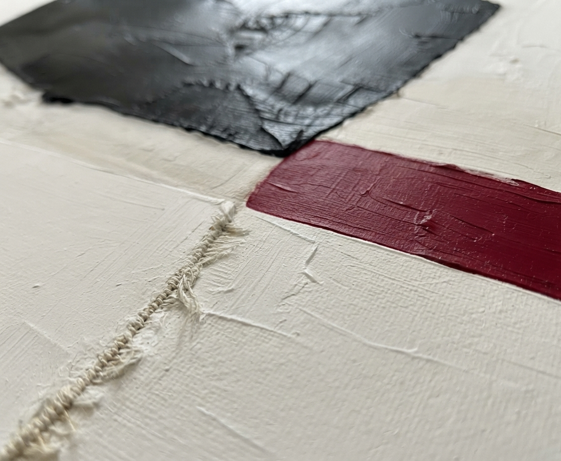 Close-up of a textured abstract painting with thick impasto brushstrokes, featuring a black rectangular section, a deep red horizontal band, and an off-white background with a frayed stitched detail. Minimalist black and white abstract canvas with red accent, original hand-painted textured acrylic artwork on canvas by Noho Art Gallery