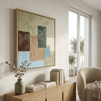 Modern living room with a Modern Geometric Oil Painting in Earth Tones by Noho Art Gallery, books, and a vase on a wooden console table.