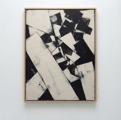 An Textured neutral abstract canvas art for a stylish modern living room by Noho Art Gallery featuring bold black and off-white geometric shapes with thick textured brushstrokes, mounted on a clean white wall.