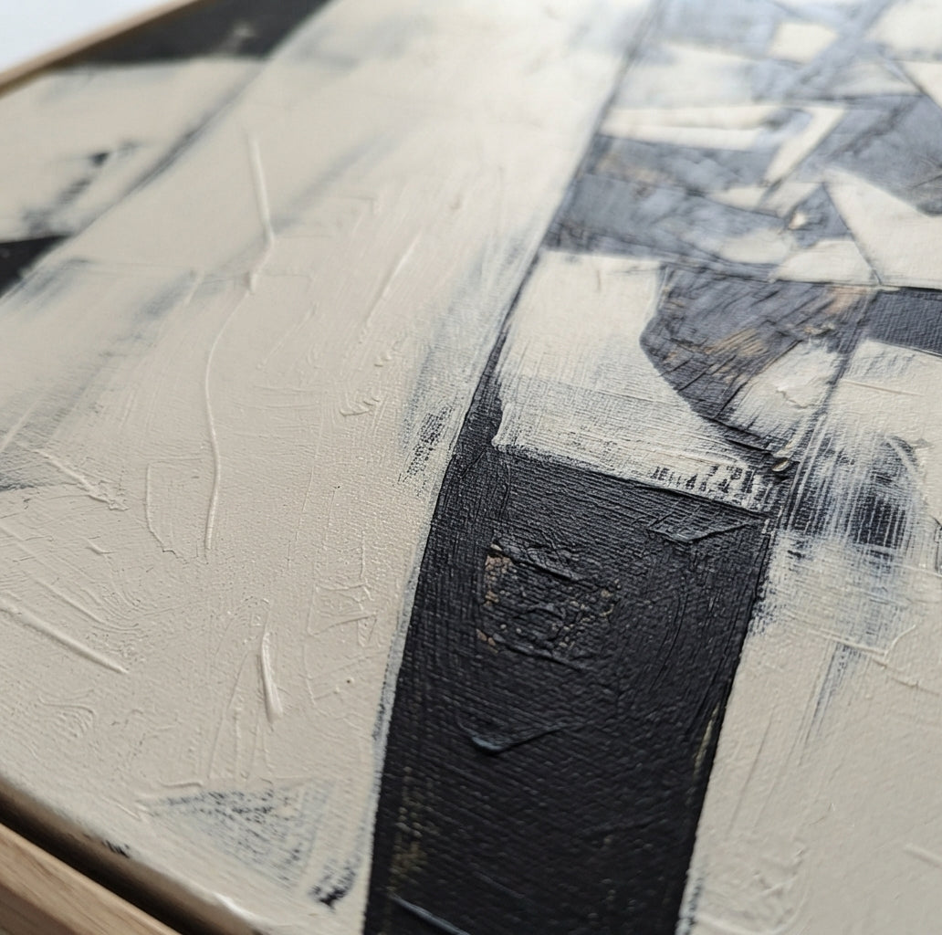 Close-up of an Contemporary monochrome geometric abstract painting for modern wall décor by Noho Art Gallery with thick textured brushstrokes in black, white, and warm off-white tones.