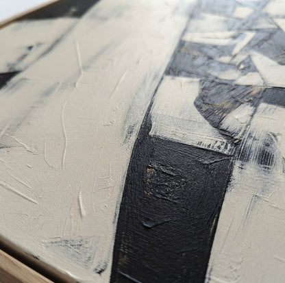 Close-up of an Contemporary monochrome geometric abstract painting for modern wall décor by Noho Art Gallery with thick textured brushstrokes in black, white, and warm off-white tones.
