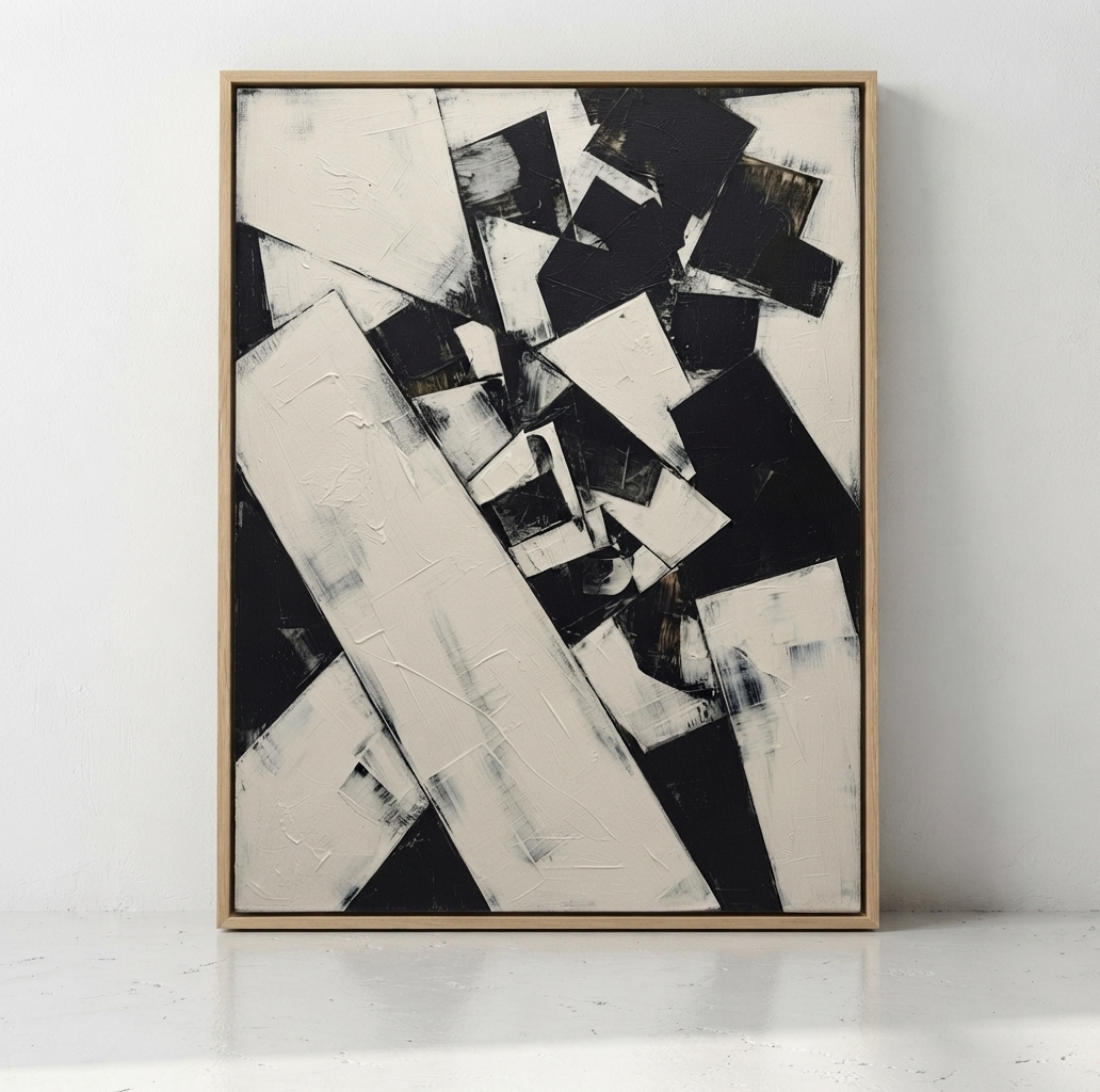 Luxury original black and white abstract painting for contemporary home interiors by Noho Art Gallery in a light wood frame, leaning against a white wall on a white surface.