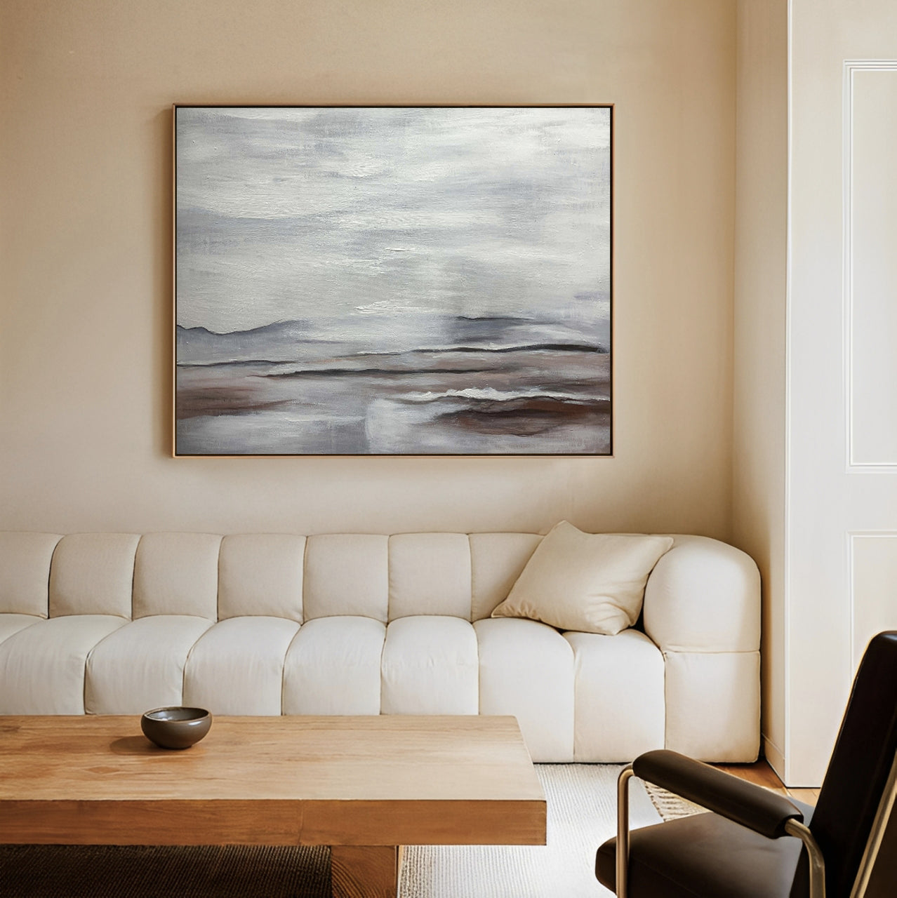Living room with a beige sofa, wooden coffee table, and abstract painting on the wall.