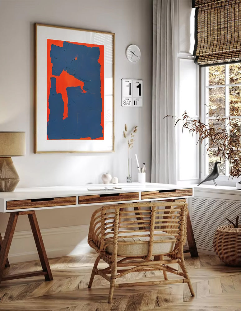 Home office with a desk, chair, and abstract art on the wall.