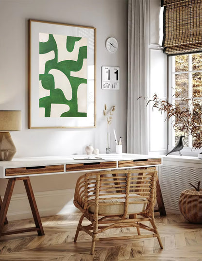 Home office with a desk, chair, and abstract green artwork on the wall.