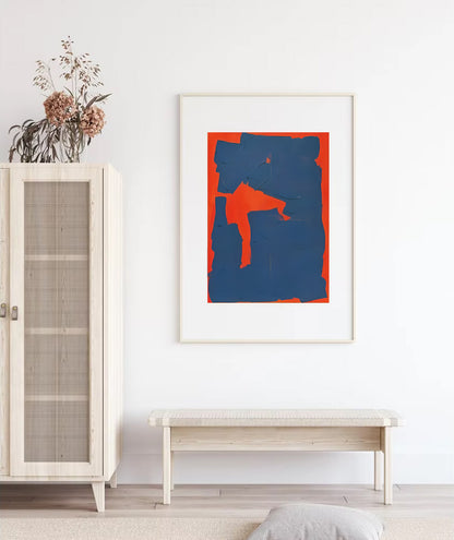 Framed abstract art piece on a wall with a cabinet and bench in a room.