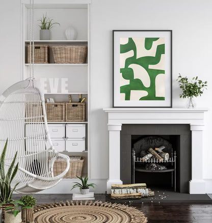 Modern living room with a white fireplace, wicker chair, and abstract green artwork.
