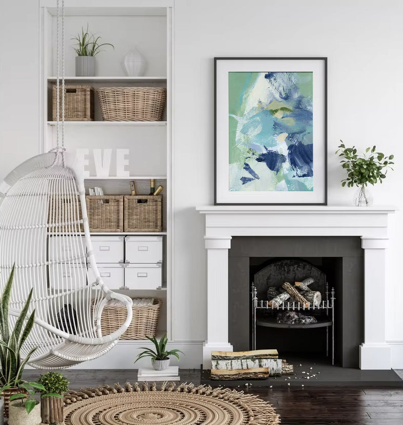 Living room with a white fireplace, hanging chair, and abstract art on the wall.