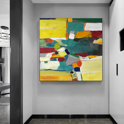 Abstract painting with colorful blocks on a gray wall