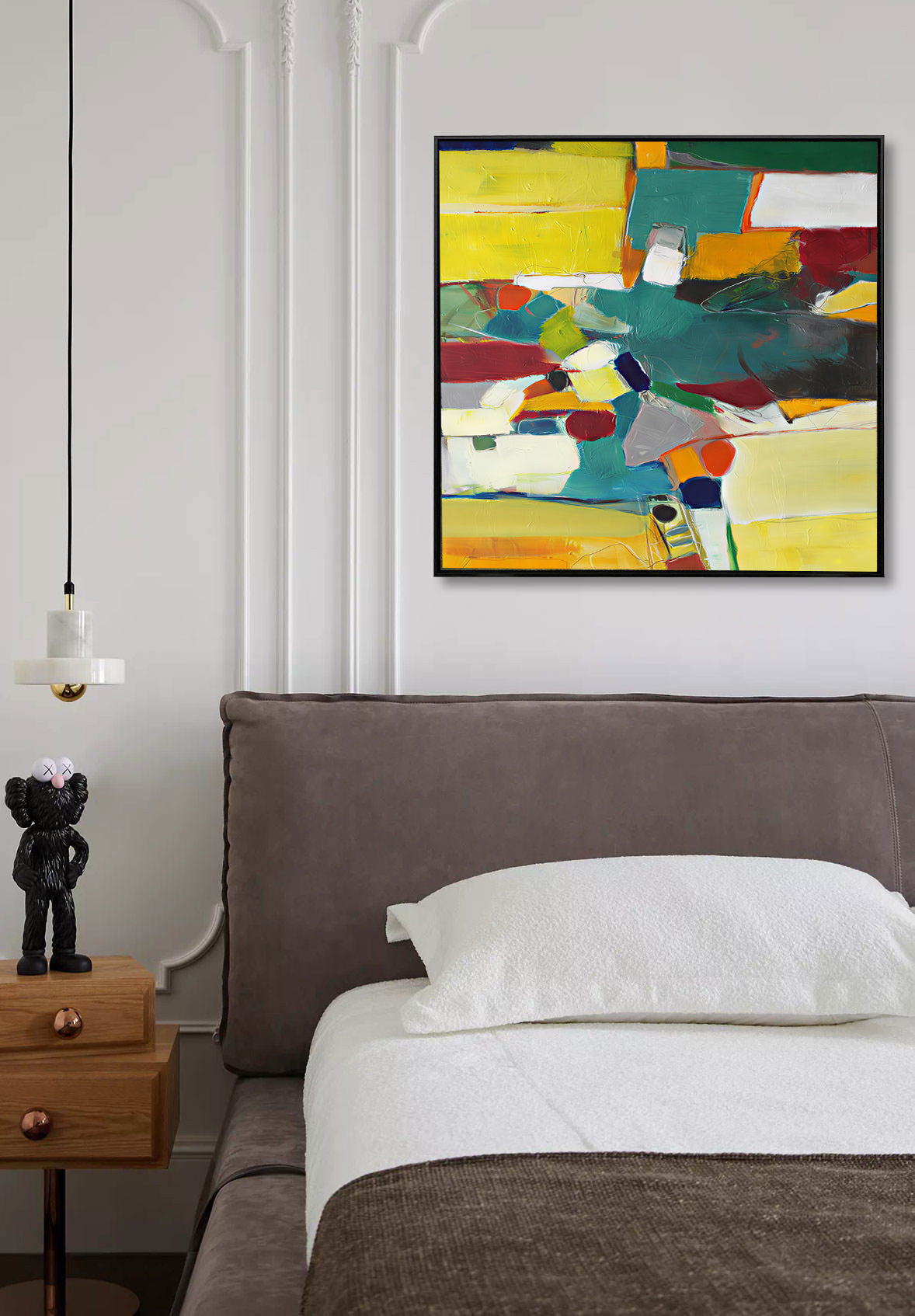 Abstract colorful painting above a bed in a bedroom setting.