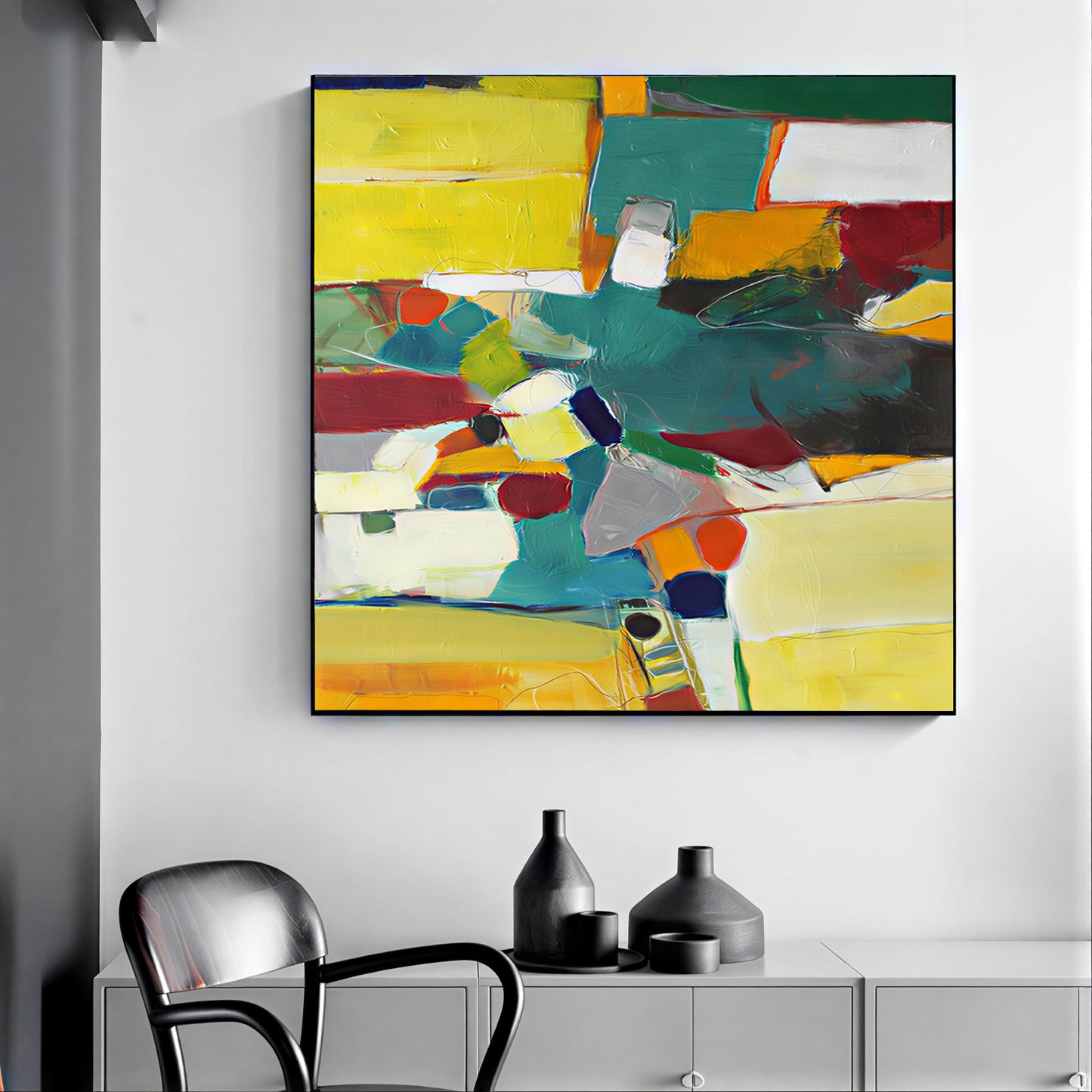 Abstract colorful painting on a wall above a modern chair and cabinet.