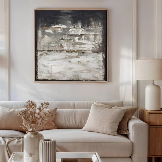 Living room with a beige sofa, abstract painting, and decorative items.